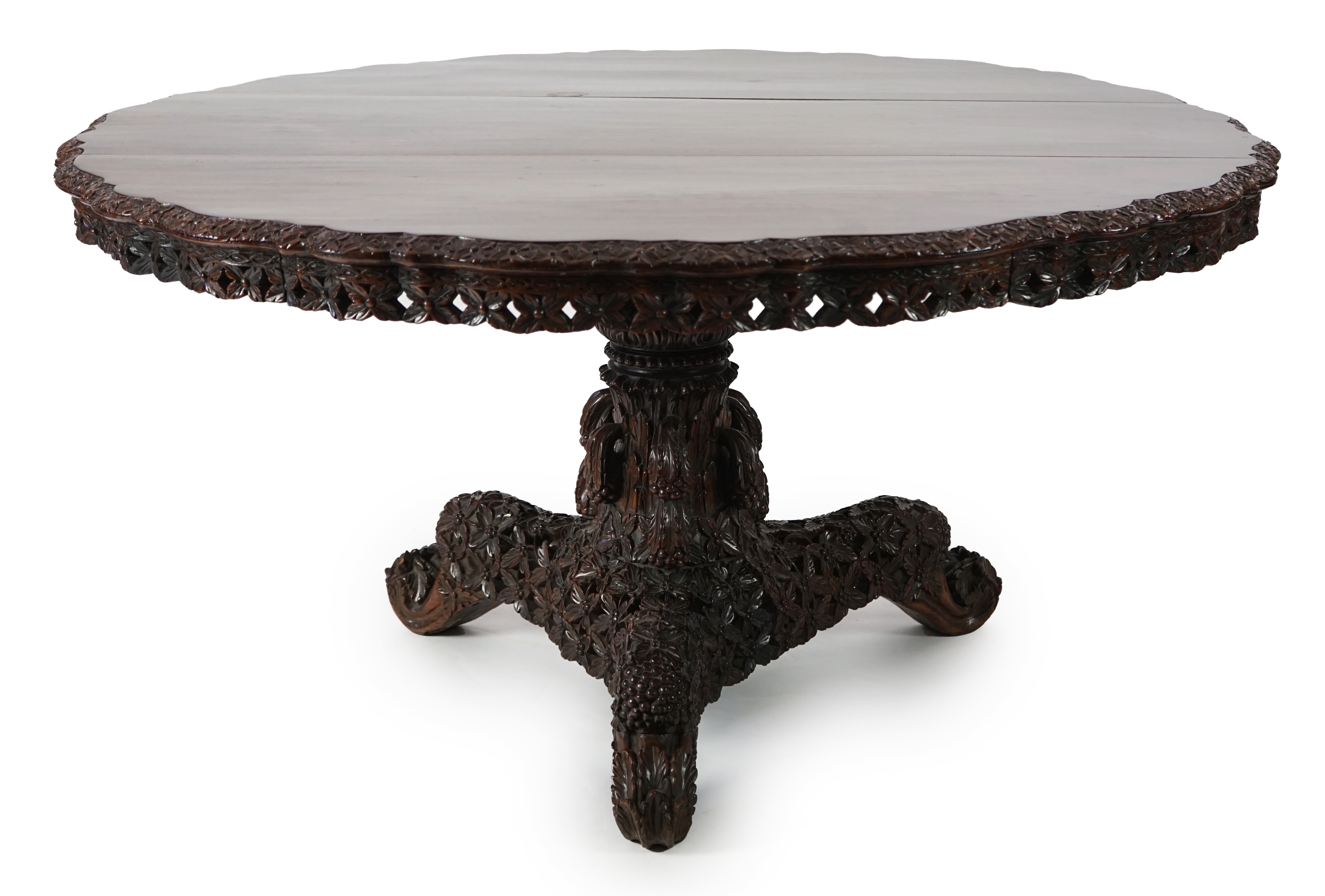 A 19th century Anglo-Indian hardwood foliate carved tilt top centre table